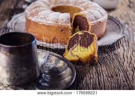 Marble cake.Easter Cake. Marble cake cup of coffee powder sugar and kitchen vintage utensil.
