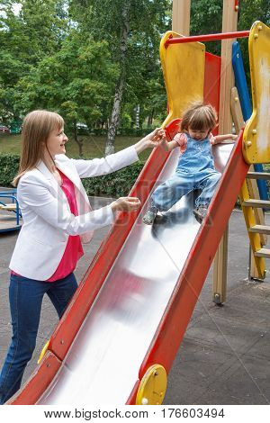 Mother with baby girl riding on hutches with screw up one eyes