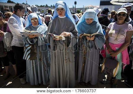 Fatima Portugal - May 13 2014: Nuns praying at the Sanctuary of Fatima during the celebrations of the apparition of the Virgin Mary in Fatima Portugal.