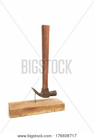 hammer nail hit into a wooden plank