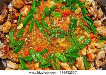 Paella from Spain recipe process ad vegetables green beans and tomato