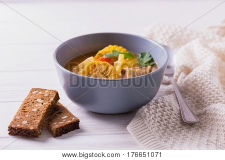 Puchero Soup With Corn And Parsley On Wooden Table