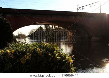 Sunshine on railway bridge over River Thames