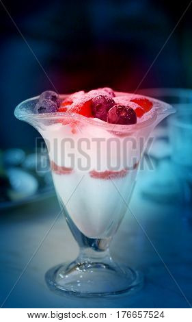 Delicious curd dessert with strawberries and blueberries with a new photographed closeup