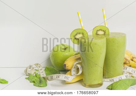 Fresh and healthy green smoothie with spinach,banana, kiwi and apple. Picture with space for text or logo