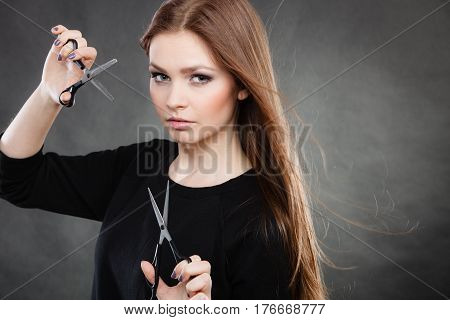 Elegance and classy. Fashion style of hairdo. Female professionalist with scissors. Elegant woman presents her hairdresser's saloon.