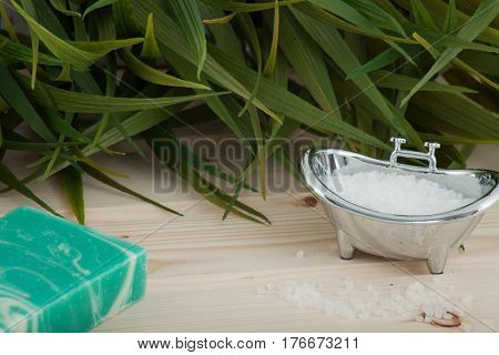 Natural bath salt, organic products placed on wooden background with spa elements