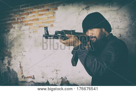 Terrorist In Black Uniform And Mask With Kalashnikov