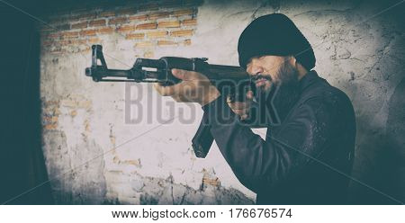 Terrorist In Black Uniform And Mask With Kalashnikov