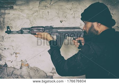 Terrorist In Black Uniform And Mask With Kalashnikov