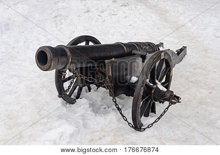 Ancient cannon in castle Palanok of Mukachevo Ukraine. Winter time white snow background.