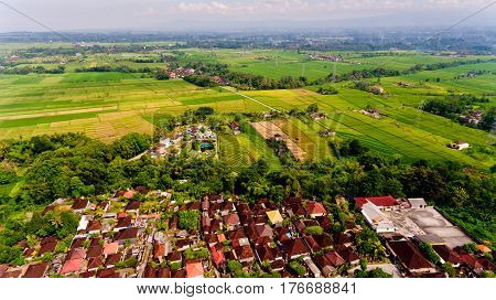 Beautiful landscape with balinese village and rice fields, Bali, Indonesia. Aerial view.