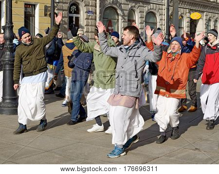 12.03.2017.Russia.Saint-Petersburg.On the street gathered followers of Lord Krishna.Young people are dancingcollecting alms and distributing sweets.