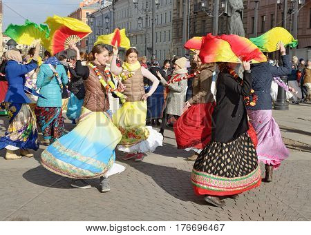 12.03.2017.Russia.Saint-Petersburg.On the street gathered followers of Lord Krishna.Young people are dancingcollecting alms and distributing sweets.