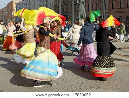 12.03.2017.Russia.Saint-Petersburg.On the street gathered followers of Lord Krishna.Young people are dancingcollecting alms and distributing sweets.
