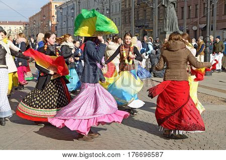 12.03.2017.Russia.Saint-Petersburg.On the street gathered followers of Lord Krishna.Young people are dancingcollecting alms and distributing sweets.