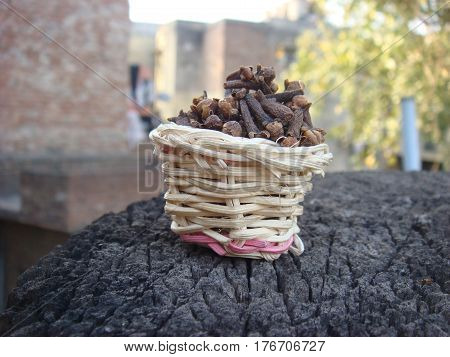 Small bamboo basket full of dried cloves