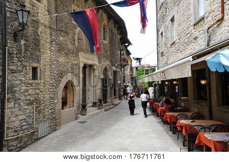 Tourists Eating On A Restaurant Of Borgo Maggiore On San Marino