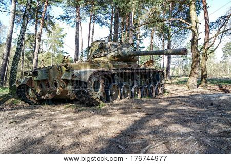 Battle tank in the moor of a forest