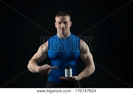 Handsome Bodybuilder Man With Muscular Body Holds Pill Jar, Steroids