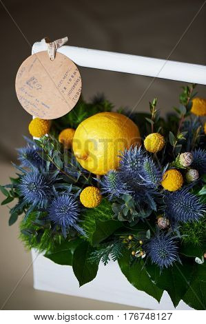 A spring bouquet in a white wooden box in the yellow-green spectrum. lemon.
