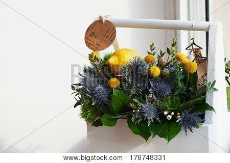 A spring bouquet in a white wooden box in the yellow-green spectrum. lemon.
