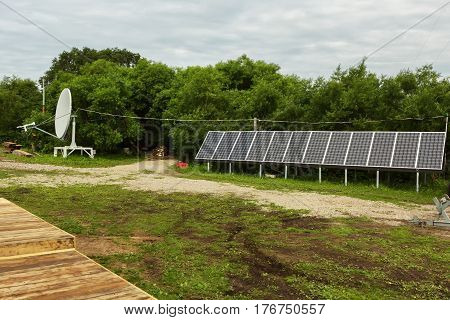 Kamchatka Peninsula, Russia - August 13, 2016: Solar panels and satellite dish on the source of river Ozernaya on Kurile lake. South Kamchatka Nature Park.