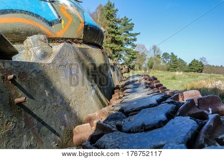 Battle tank in the moor of a forest