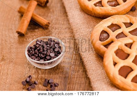 Chocolate tart with cocoa powder on wooden table.