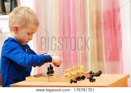Young Kid Boy Playing Chess Having Fun