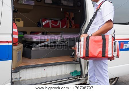 male nurse carry nursing bag standing beside ambulance prepare for helping people