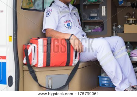 male nurse sitting at the ambulance filled with equipment prepare for helping people