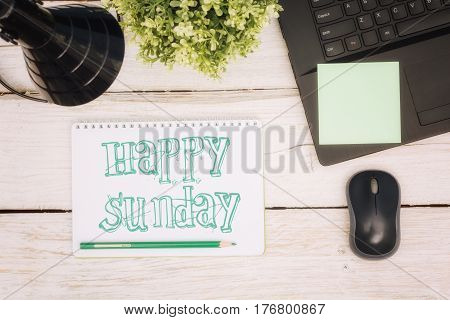 Workspace notebook and inscription in a scratchpad: happy sunday