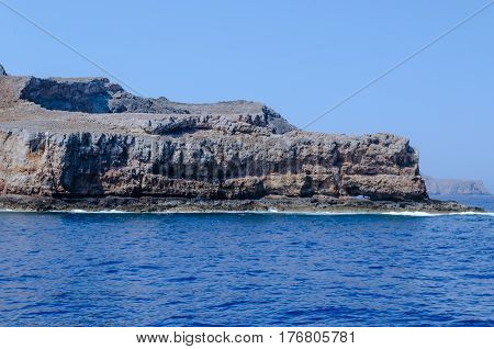 The rocky coast of the Mediterranean sea against the blue sky on a clear summer day
