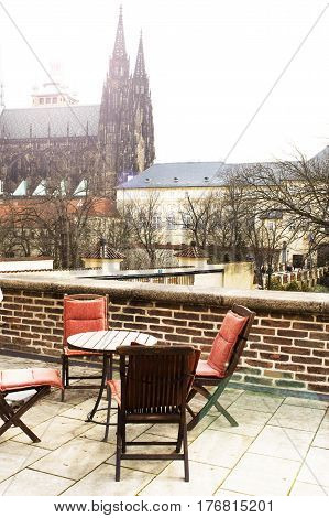 chairs and wooden table on the terrace sunny hot day in Europe