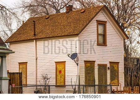 Abandoned Home With Boarded Up Windows & Doors