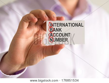 Businessman Holding A Card With Iban International Bank Account Number Message