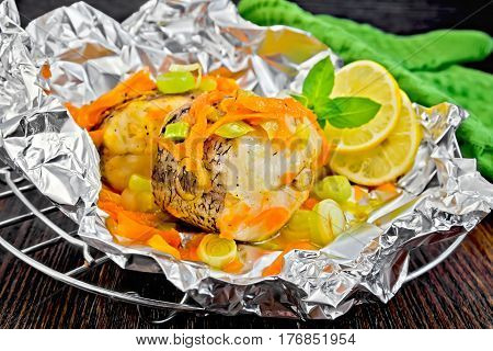 Pike With Carrots And Lemon In Foil On Board