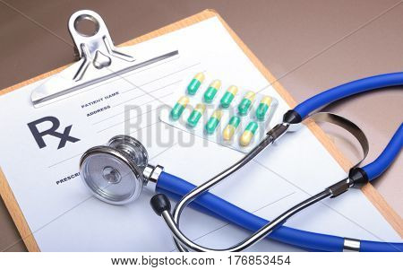 RX prescription, Red heart, asorted pils and a stethoscope on white background.