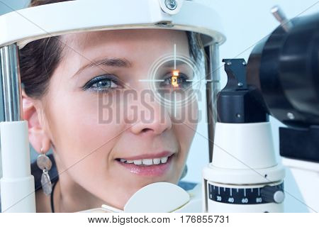 Checking eyesight in a clinic of the future, young girl. Ophthalmology. Future medicine and health concept. Virtual laser for checking vision.