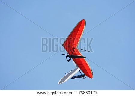 Hang gliders flying in a blue sky