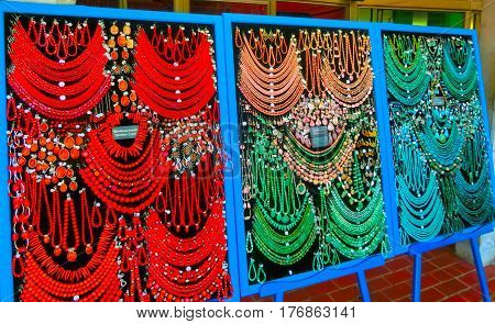 Postojna, Slovenia - May 9, 2014: Lot of colored beads from different minerals and stone background at souvenir shop at Postojna, Slovenia on May 9, 2014: