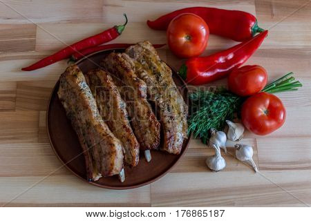 Food background Grilled pork chop with pepper garlic and dill on wooden board - selective focus