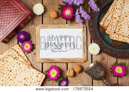Jewish holiday Passover background with photo frame matza and seder plate. View from above