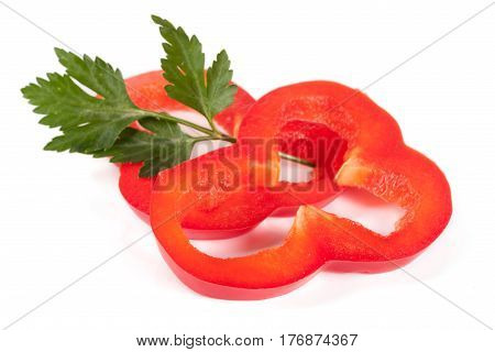 Red sweet bell pepper slices with leaf parsley isolated on white background cutout.
