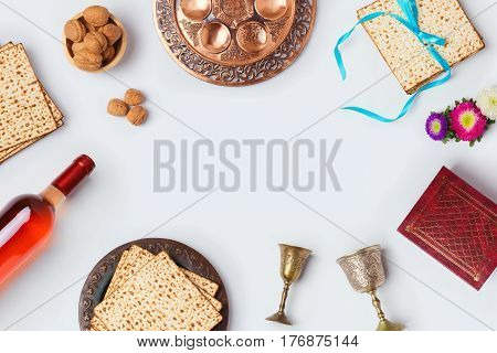 Jewish holiday Passover background with wine matza and seder plate. View from above. Flat lay