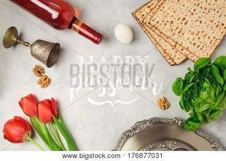 Jewish holiday Passover Pesah greeting card with seder plate matzoh and wine bottle.