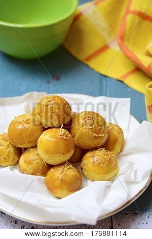 Nastar or Indonesian pineapple tart cookies topped with grated cheese