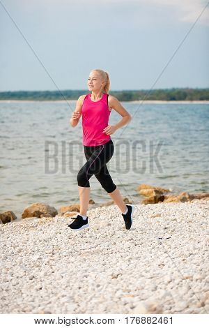 Jogging In Th Beach - Woman Runns Near Sea On Early Summer Morning