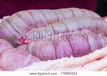 Guts inside a cut pig. Chitterlings raw